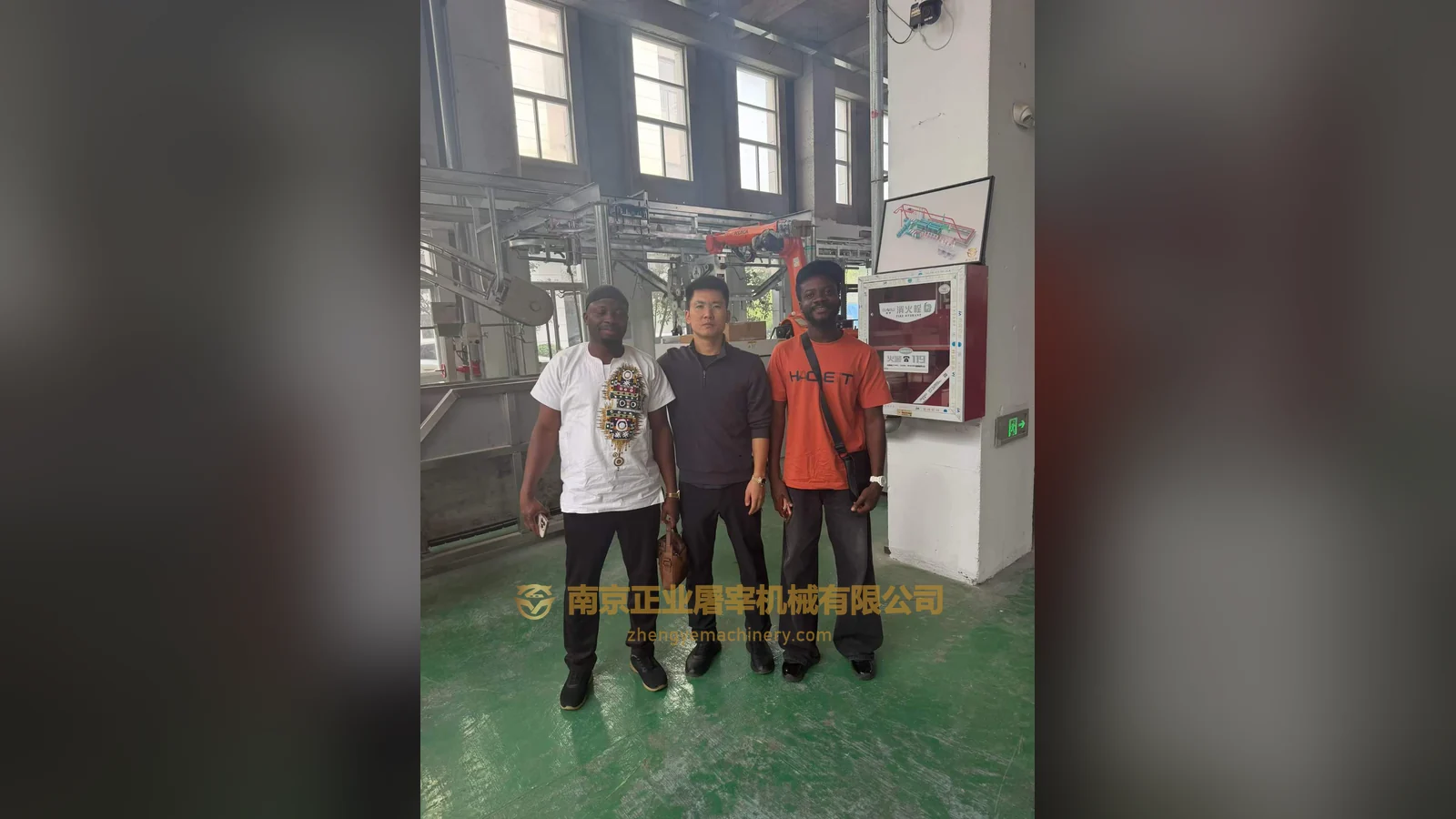 Clients from Ghana with Mr. Chen of Zhengye Slaughter Machinery beside displayed equipment, 21 October 2026