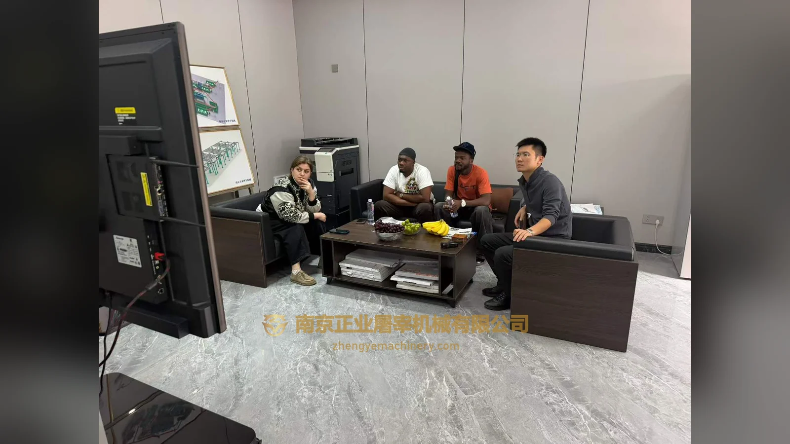 Clients from Ghana meeting Mr. Chen of Zhengye Slaughter Machinery in the reception area