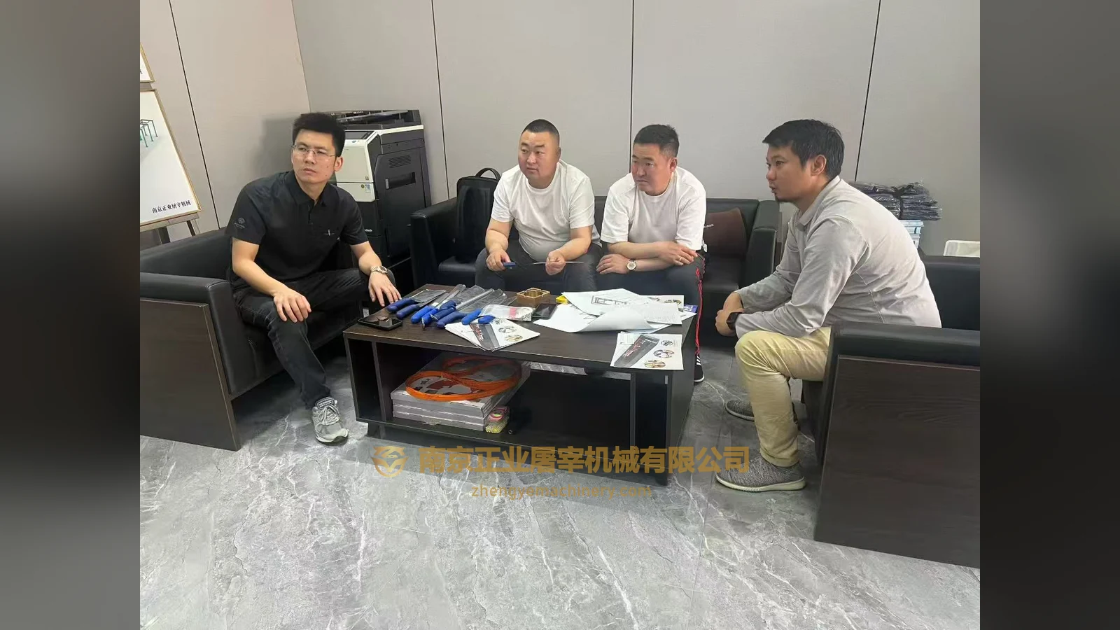 Mongolia-labelled visitors discussing papers at a table