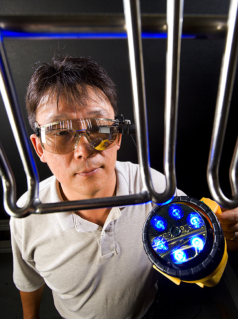 USDA ARS scientist testing a portable imaging device for food-processing equipment sanitation