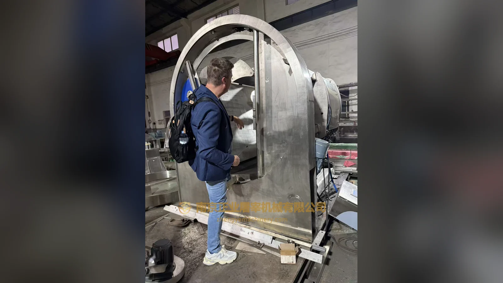 Polish clients inspect the rotary ritual slaughter box in the workshop