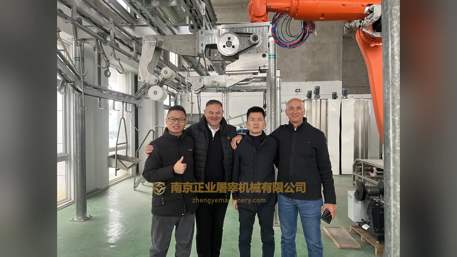 Visitors and Zhengye staff beside equipment in a workshop