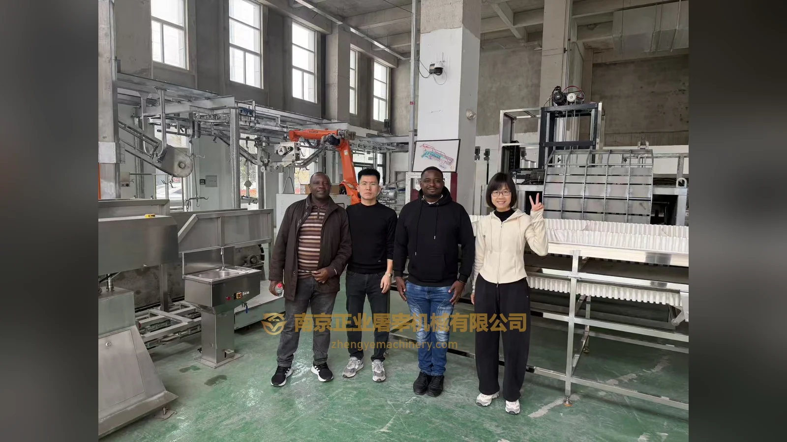 Zimbabwe-labelled visitor group inside an equipment workshop